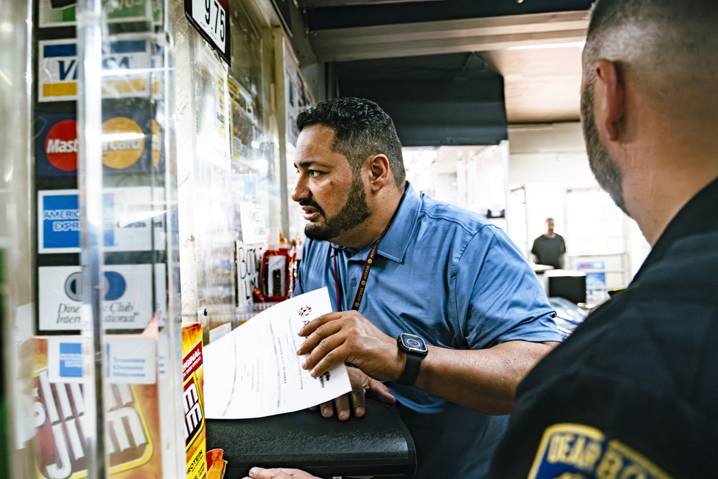 ACCESS Public Health Coordinator, Ahmad Ballout, with Dearborn Police distributing Narcan kits to local businesses.