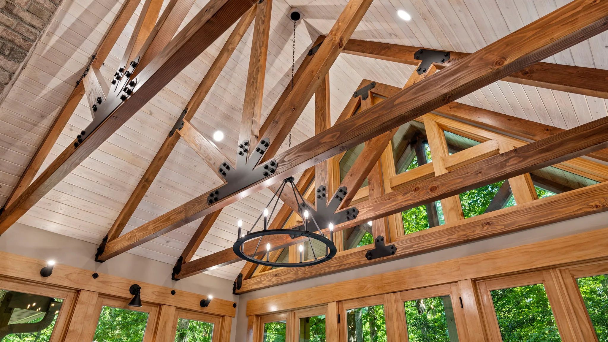A completed halsey homes project, with a lofted ceiling, exposed wood beams and natural light.