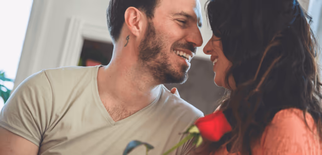 Moment of affection between husband and wife. They are face to face and smiling while embracing one another.