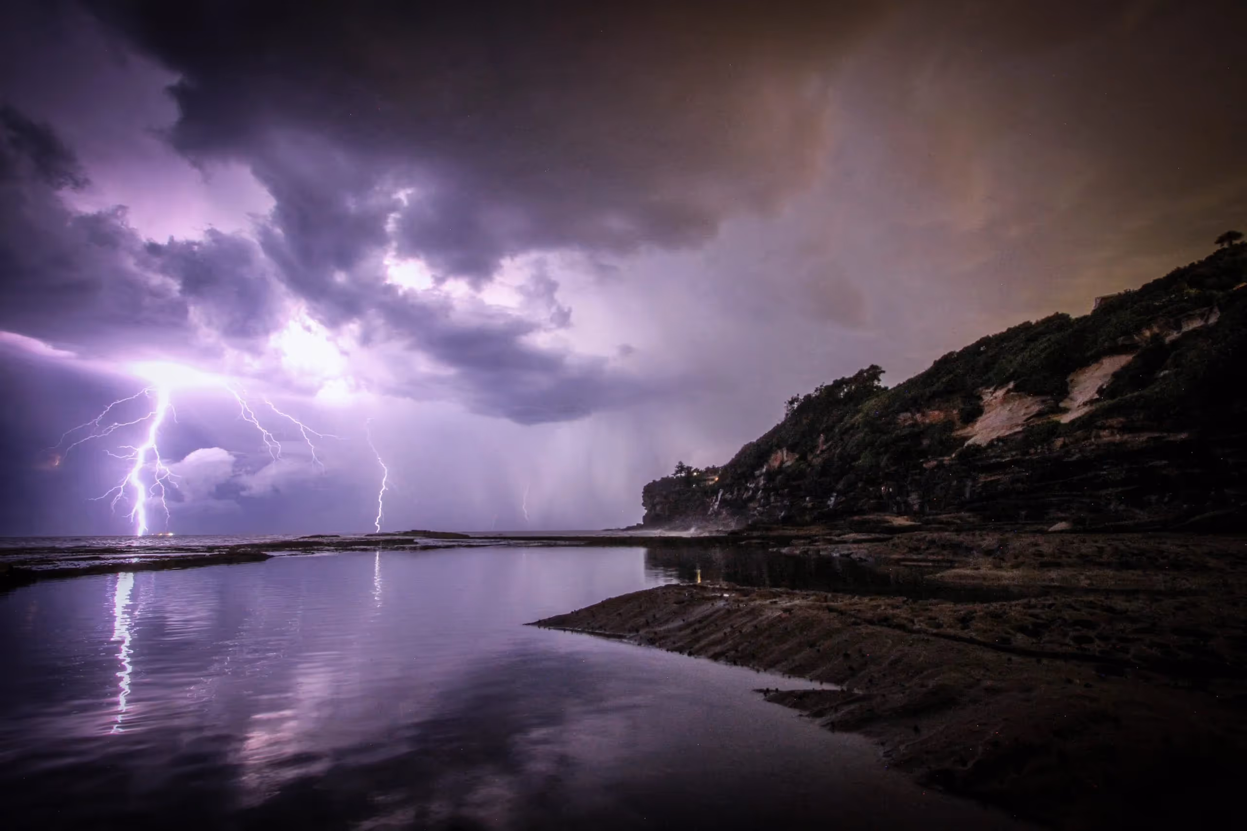 lightening strikes overtop a body of water