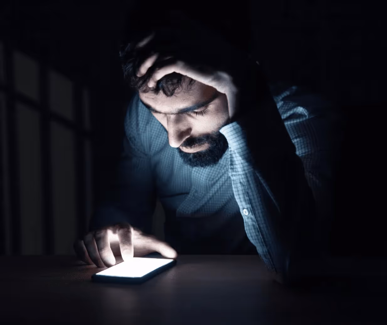 Man looking at phone in dark hypersexuality