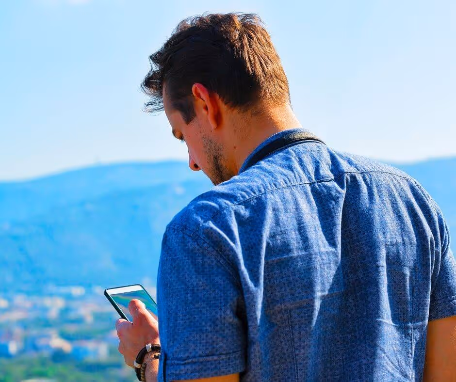 A man looking stressed as he looks at his phone