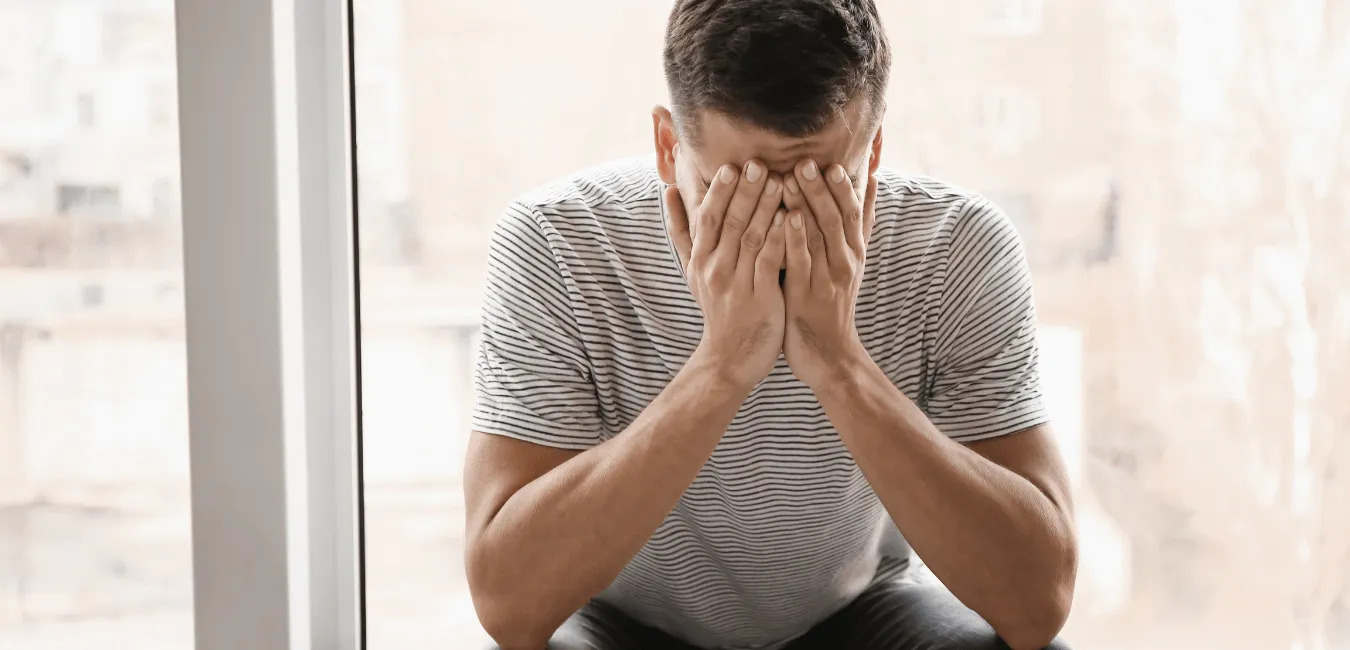 Man sits in the corner going through something