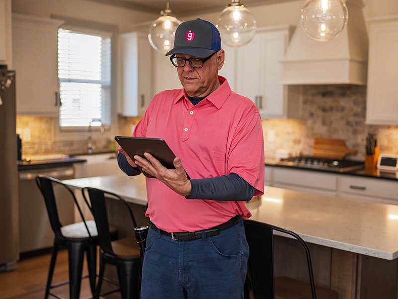 pest technician checking ipad