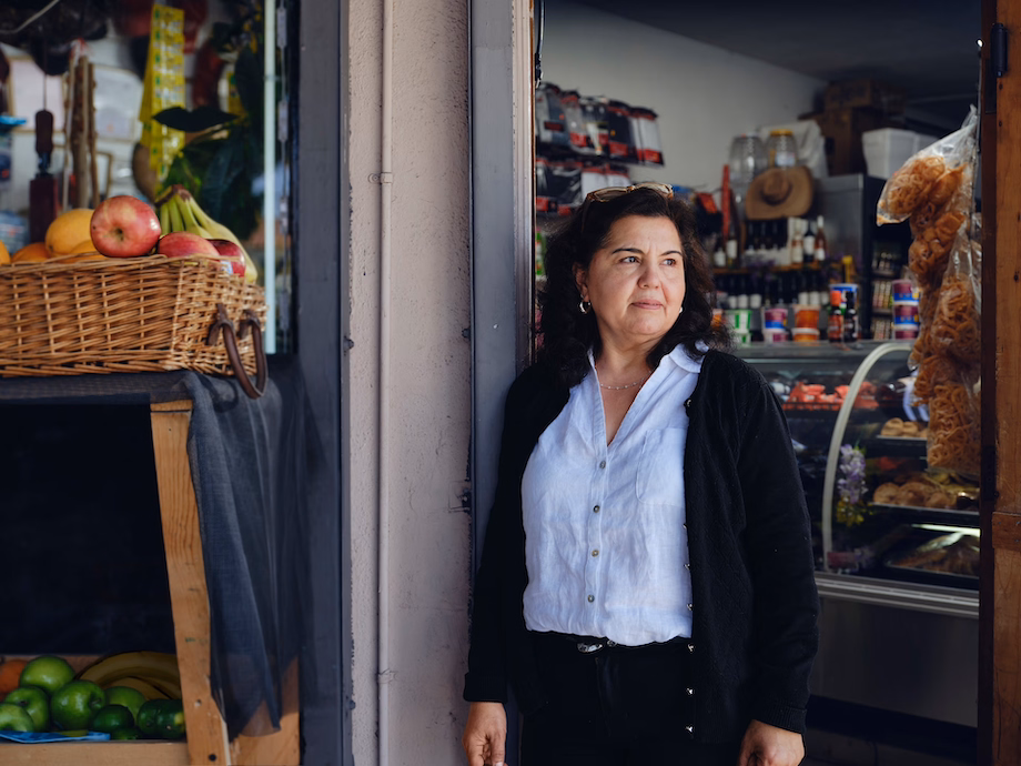 a woman standing next to a store