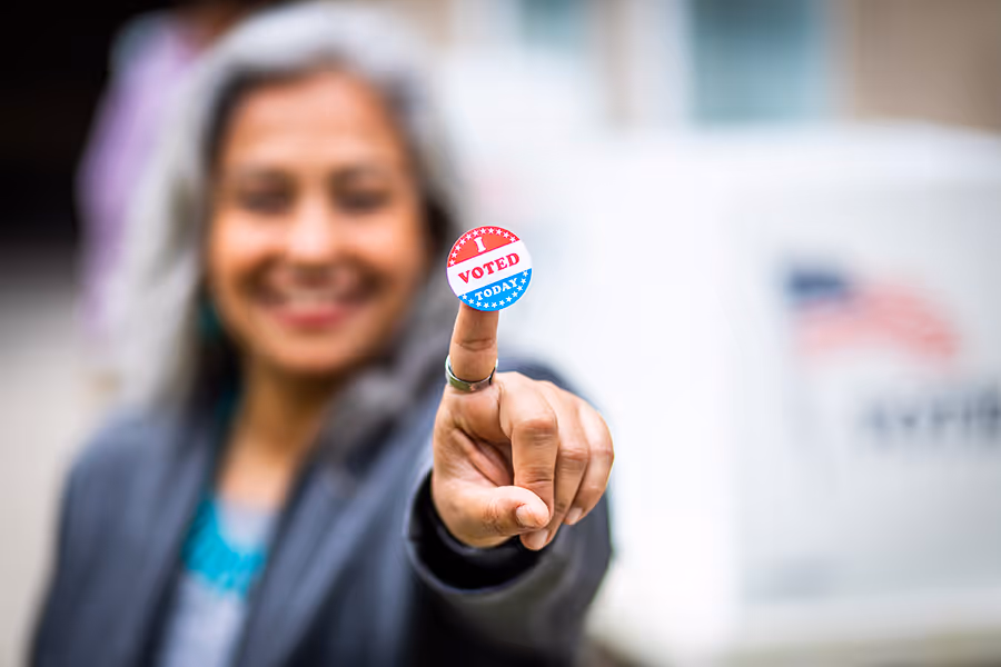 a woman pointing at a sticker