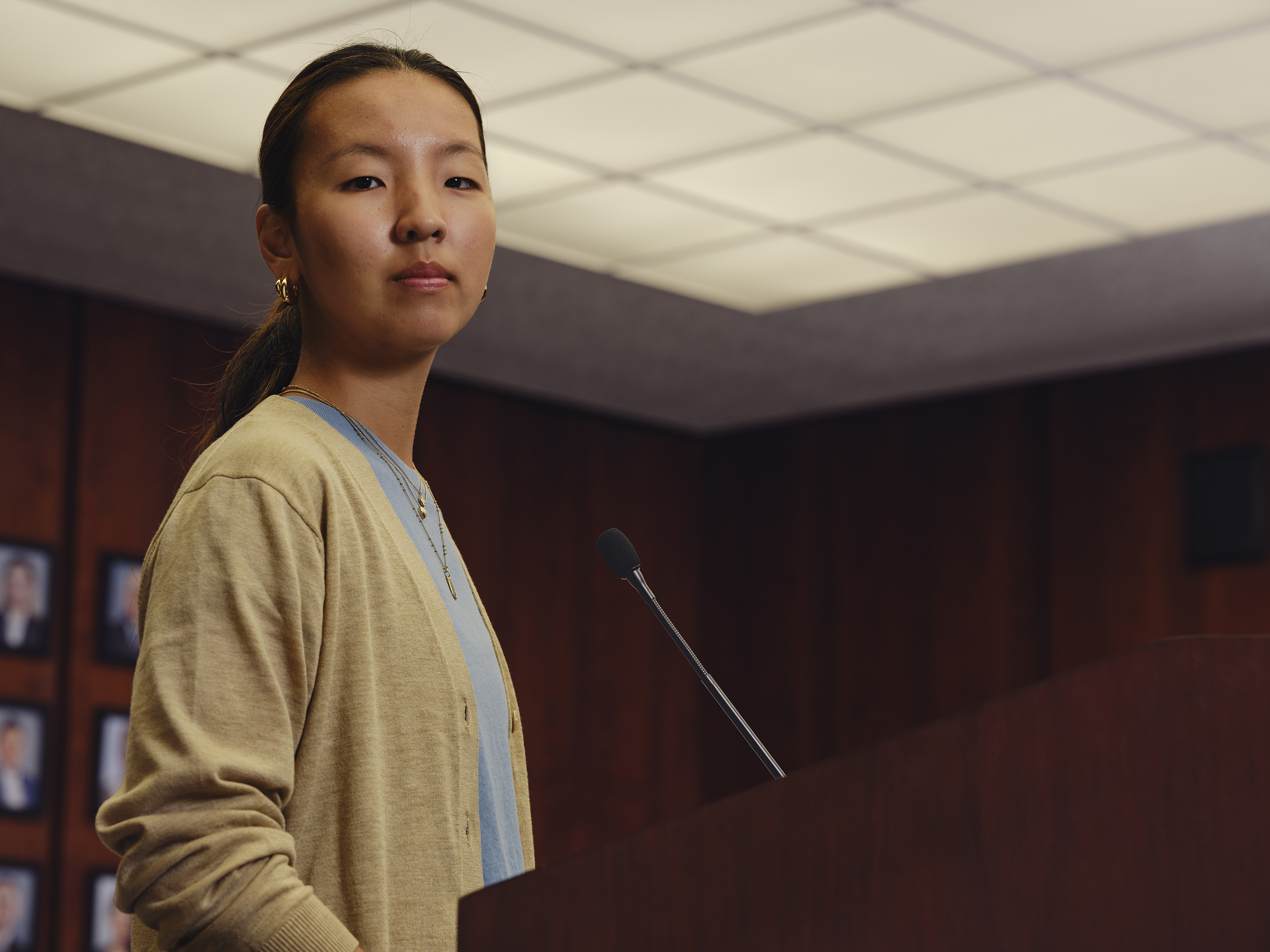 A girl at a podium with a cardigan