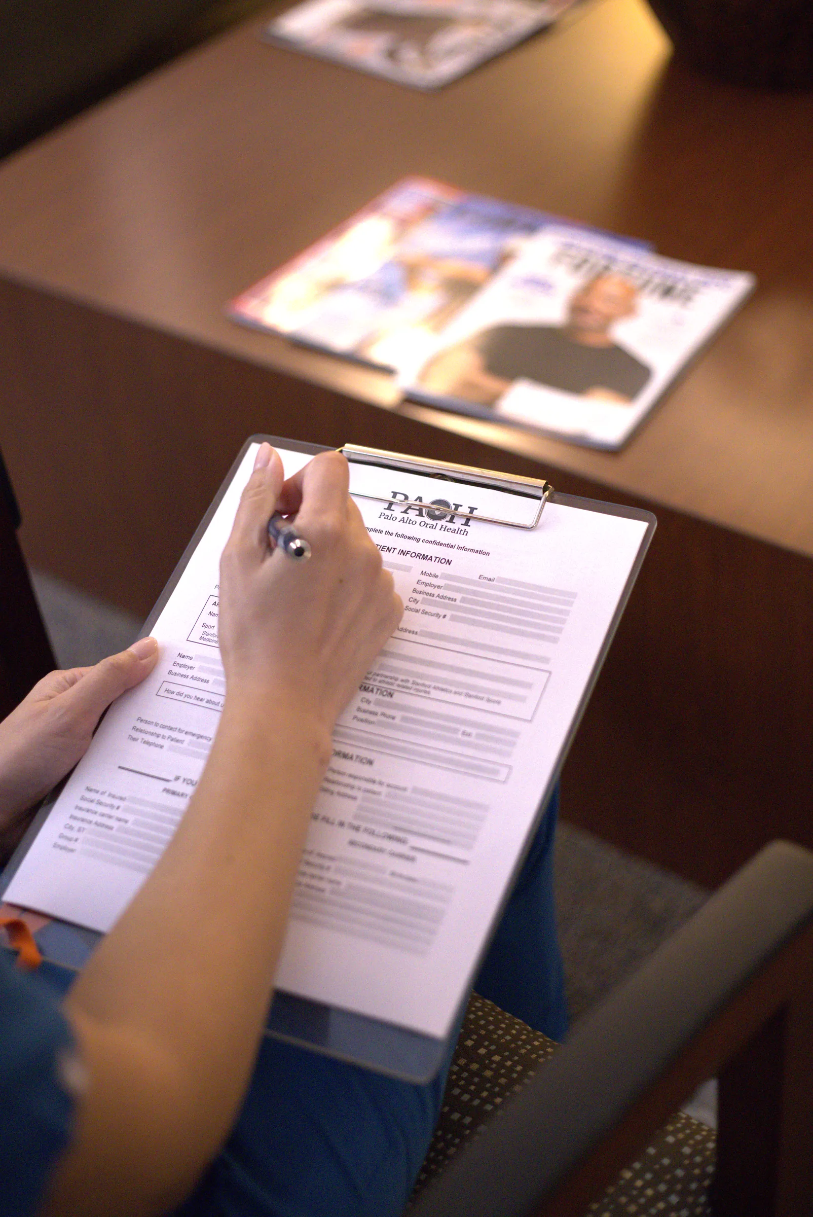 Filling out a new patient form in the waiting room