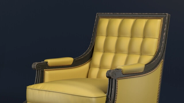 A yellow leather chair sitting on top of a wooden floor.