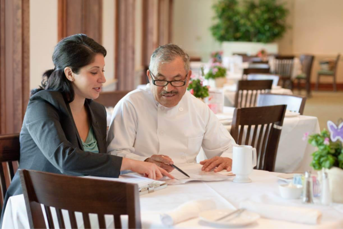 small business restaurant owners reviewing unpaid debt documents