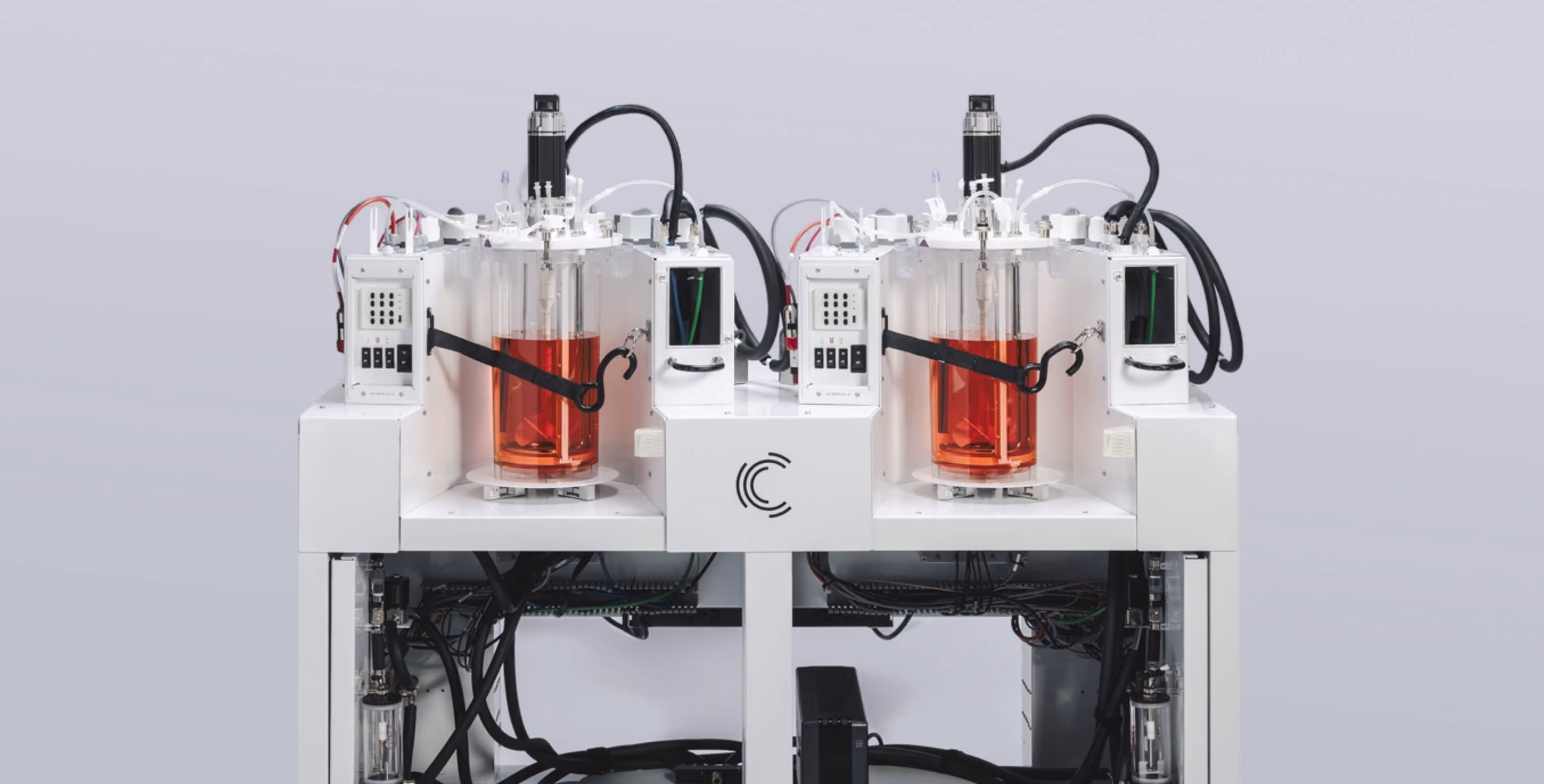 A white machine with a red liquid in it.