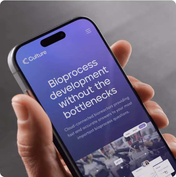 A person holding a cell phone with a website called Culture. 