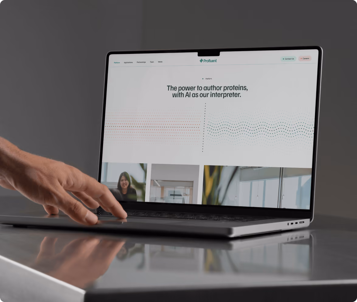 A laptop with a website open that says "the power to author proteins with AI as interpreter". 