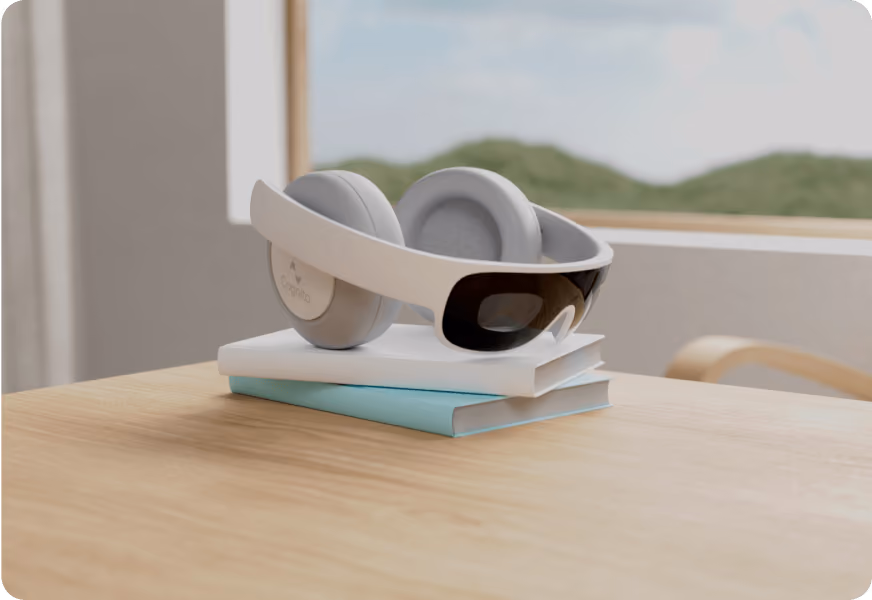 A pair of white headphones sitting on a stack of books.