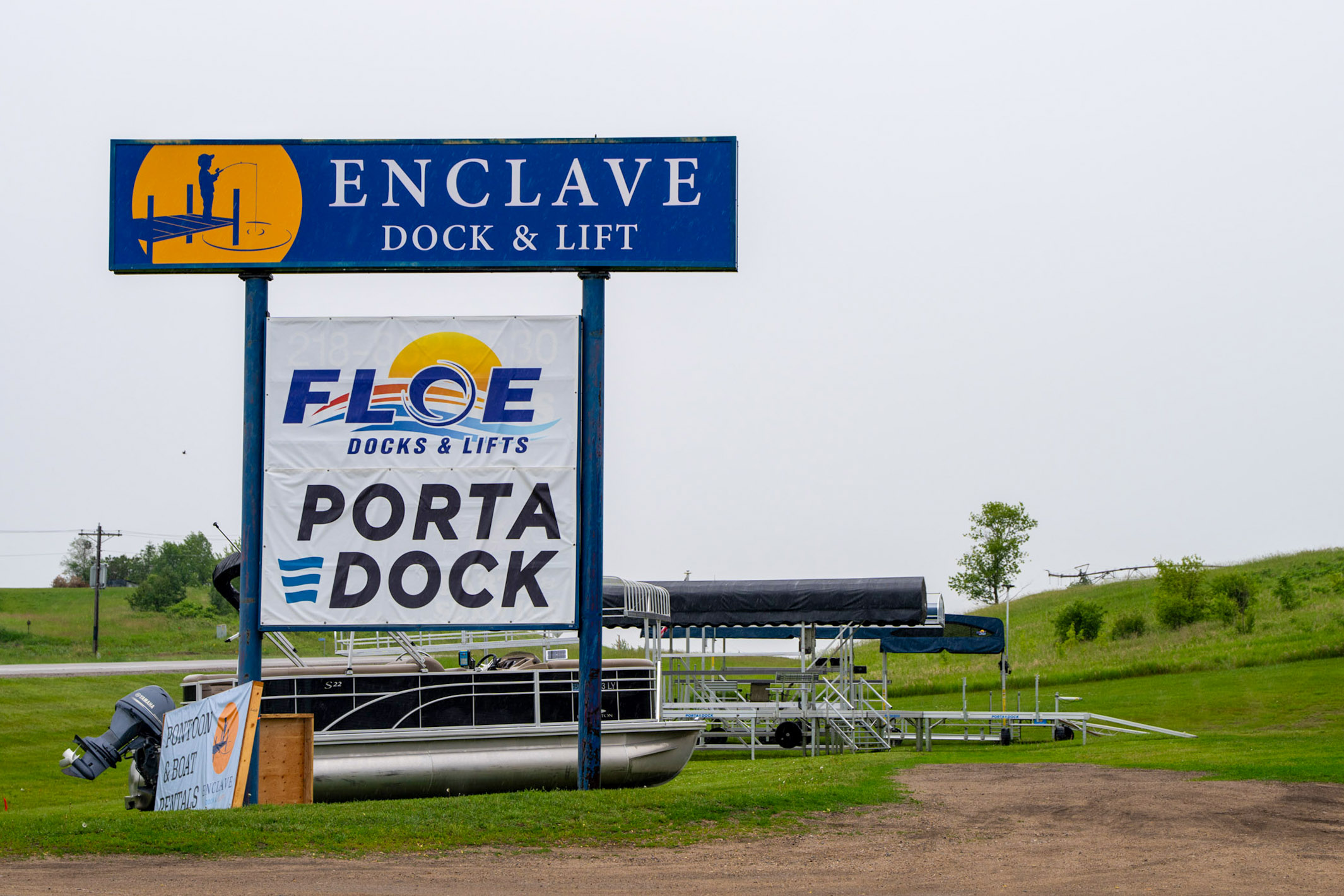 Image of Enclave Dock and Lift Sign, next to signs for Floe Docks & Lifts and Porta-Dock