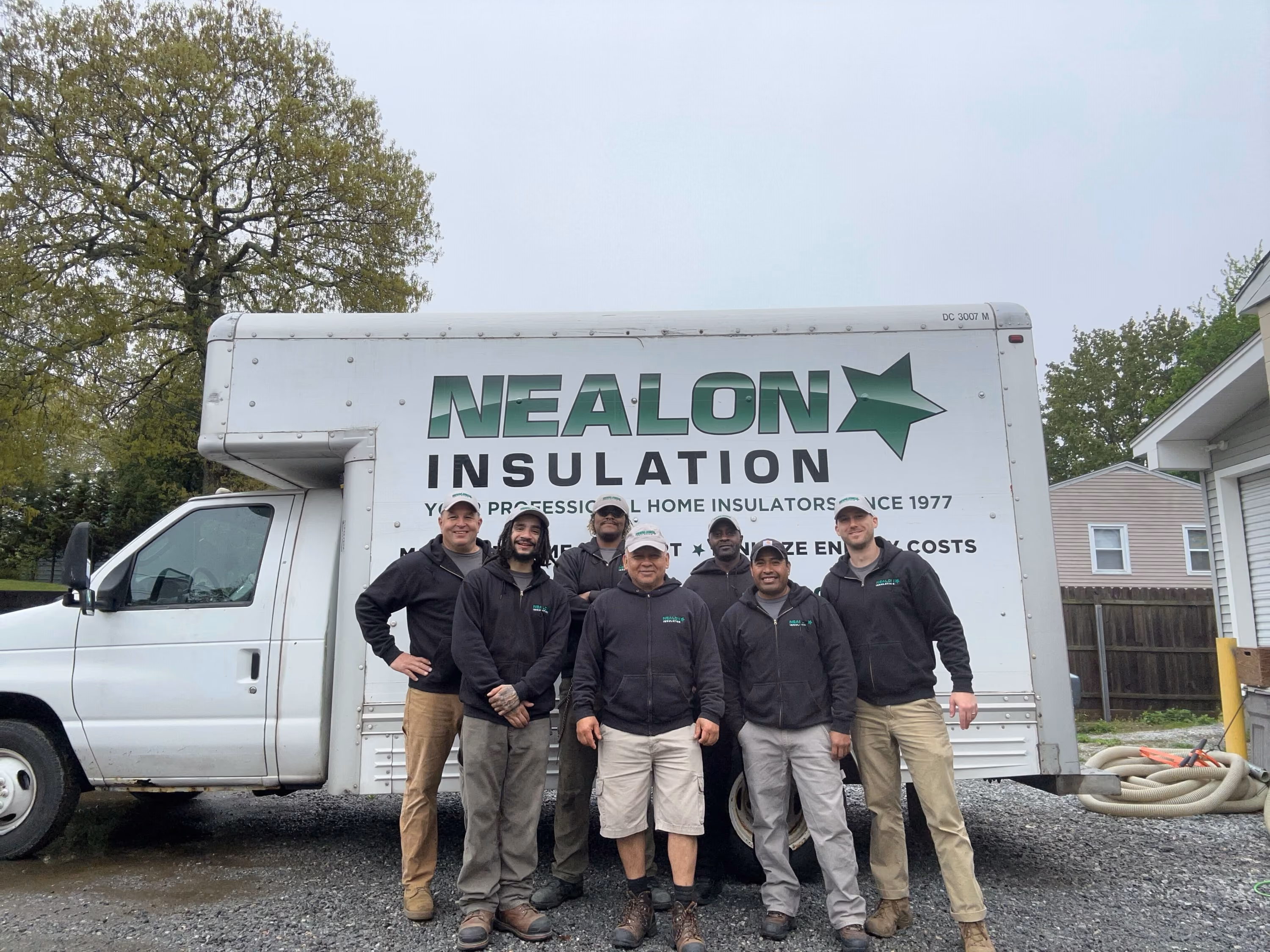 Insulation crew standing in front of Nealon Insulation service truck.