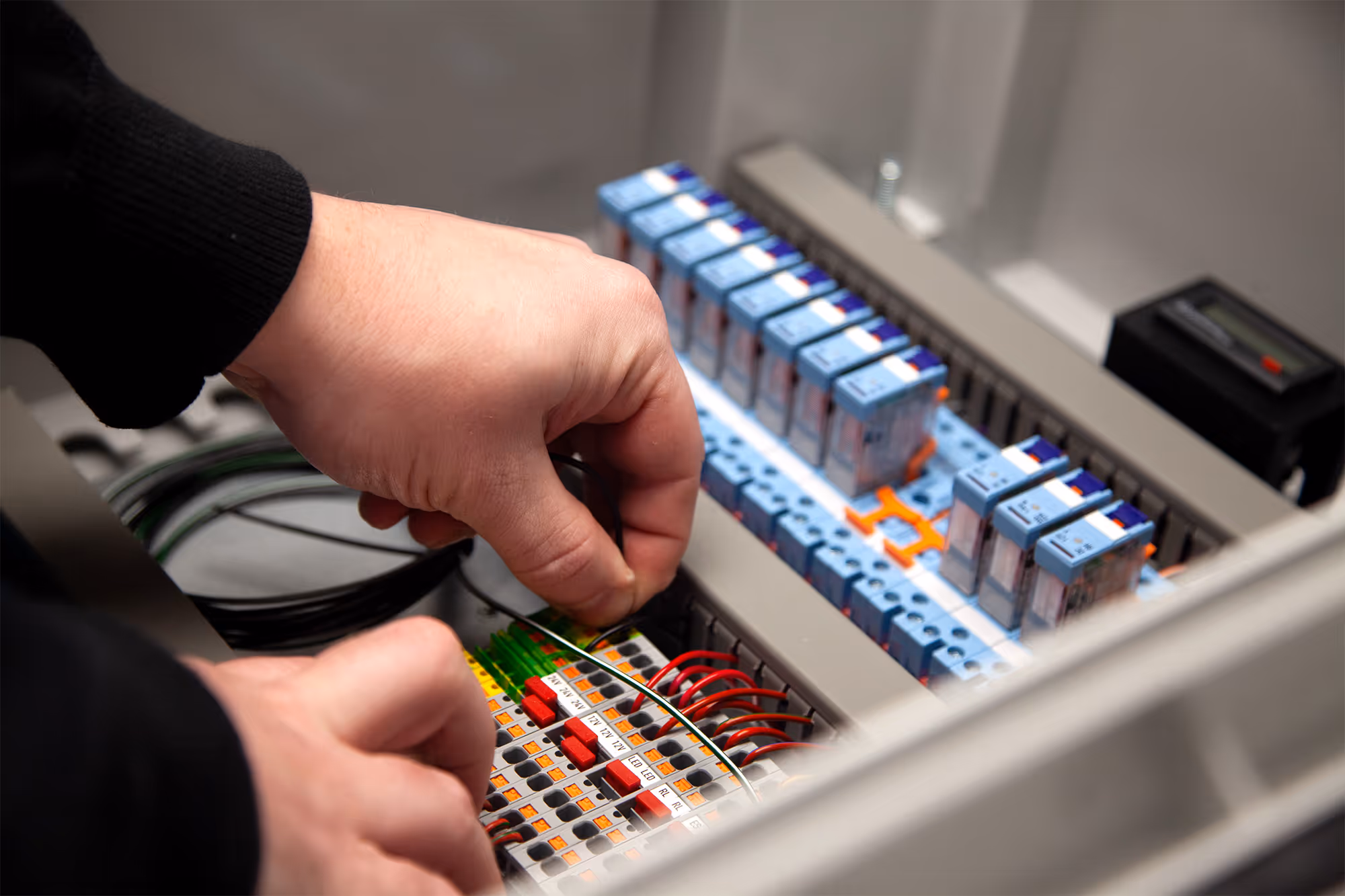 Tec‑Stop panel builder wiring a custom electrical control panel with circuit breakers and labelled terminals