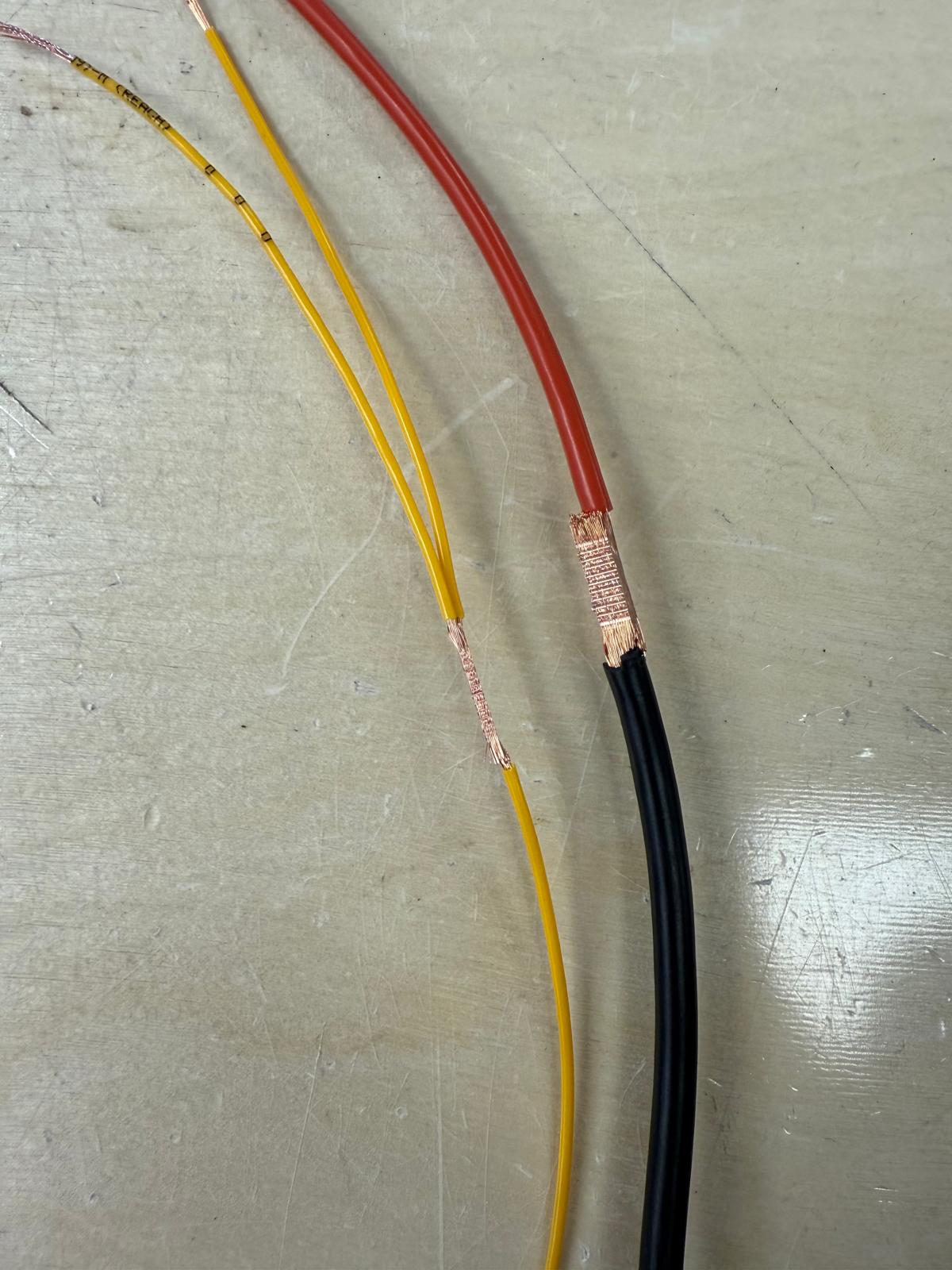 Close-up of butt crimp wire connections showing compressed copper joins, illustrating how traditional crimping compares to ultrasonic welding in Tec-Stop’s Worcester-based electrical assemblies.
