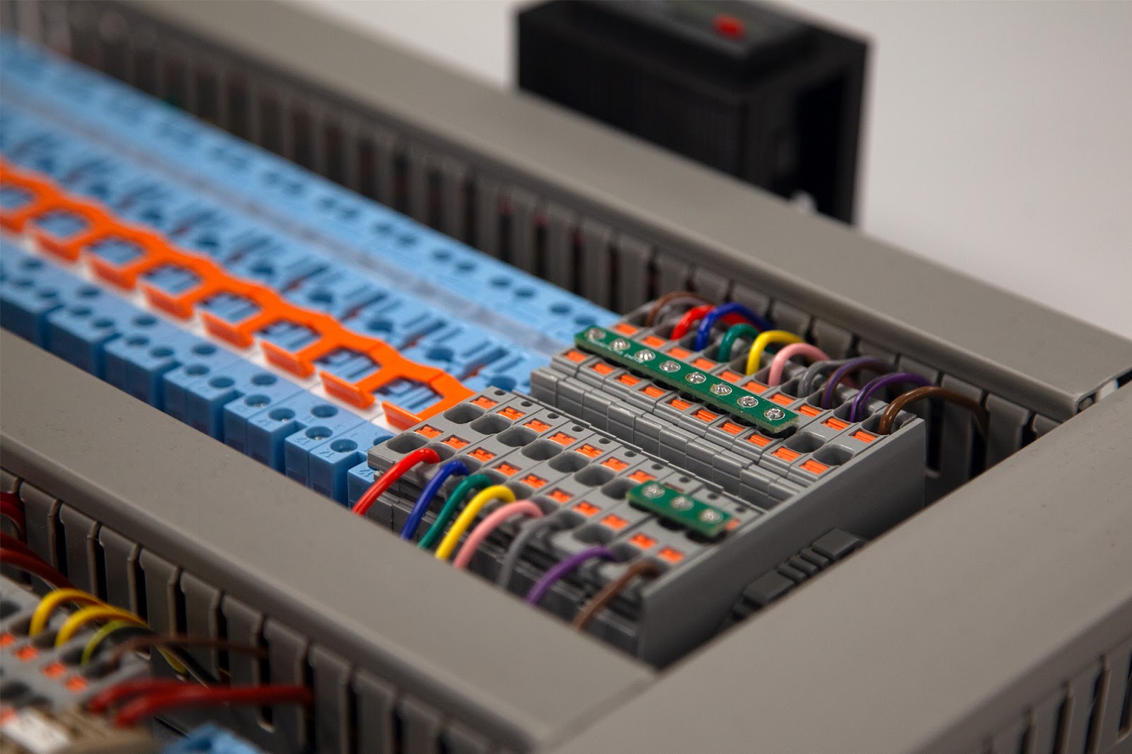 Close-up of a neatly wired bespoke electrical control panel featuring modular terminal blocks, multi-colored wiring, and precision engineering. This Tec-Stop custom-built control system demonstrates organized layout, industrial-grade components, and UK compliant design for automation and process control.