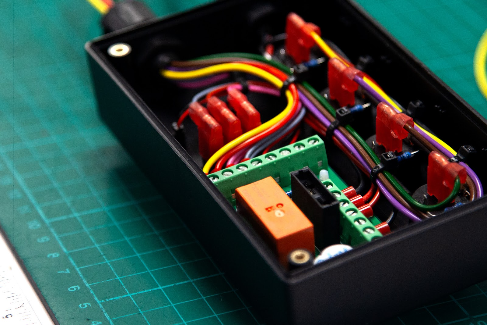 Compact electrical enclosure with fused circuits and neatly arranged custom wiring harness.