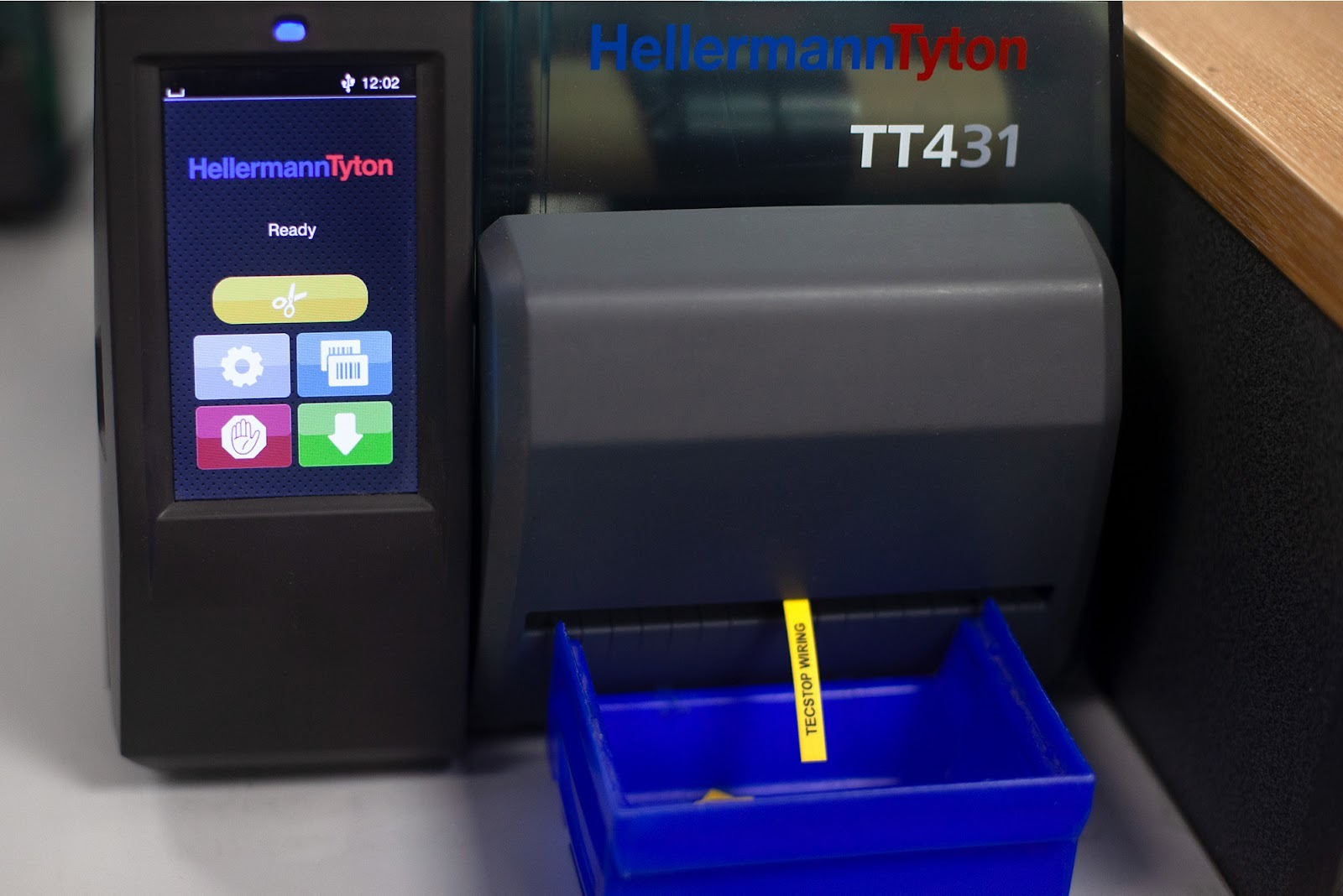 HellermannTyton TT431 printer producing yellow colour-coded cable markers for controlled wiring systems.