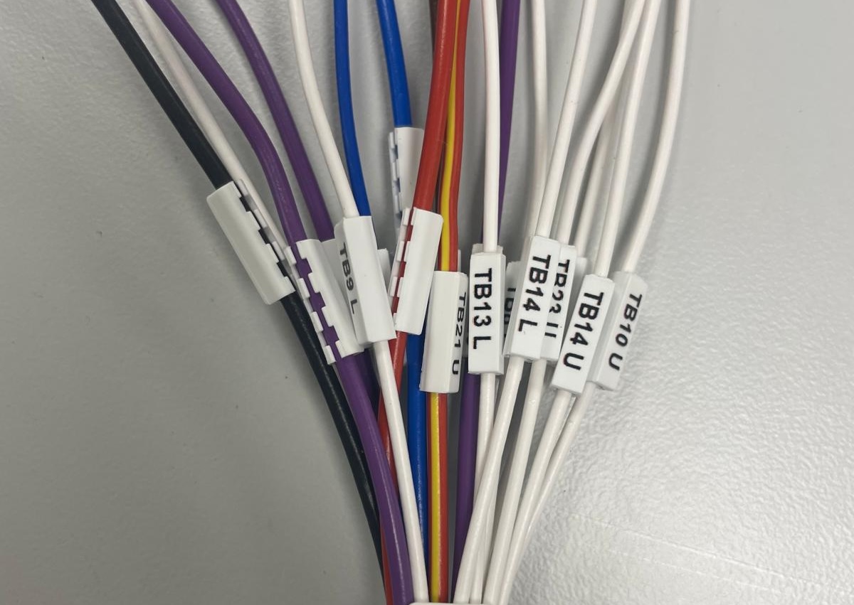 Labelled wiring looms bundled for OEM assembly, showing clear identification for installation and maintenance.