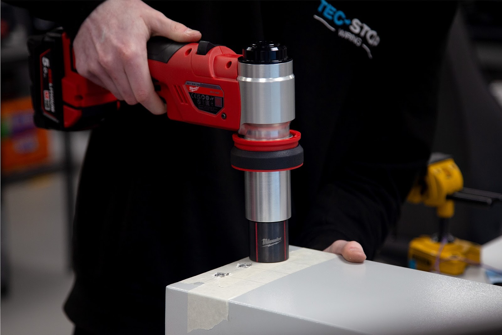 Engineer using precision tooling to modify electrical enclosure during value added engineering and prototype preparation