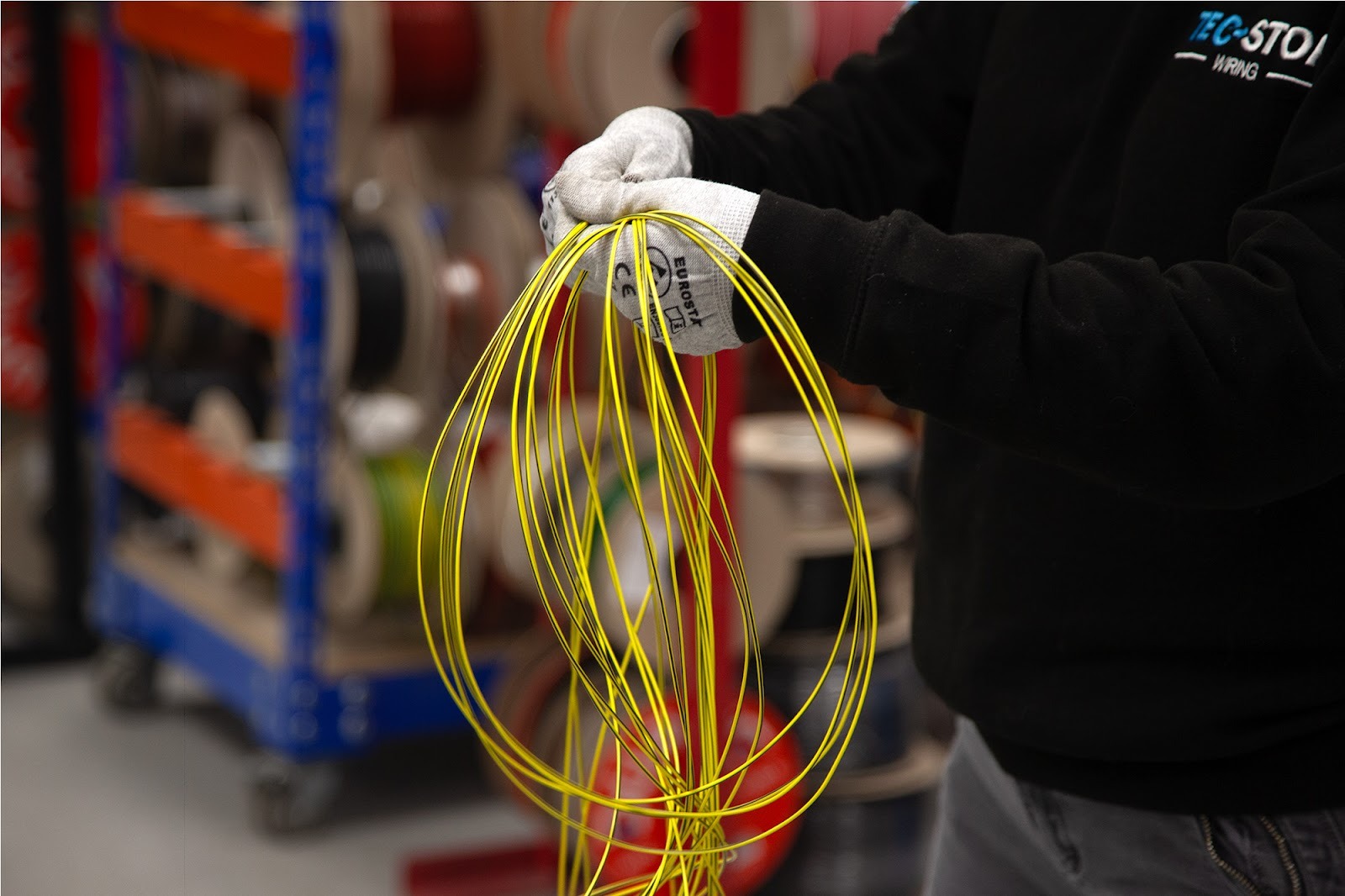 Wire harness preparation showing grouped conductors before protective sleeving in a wiring loom