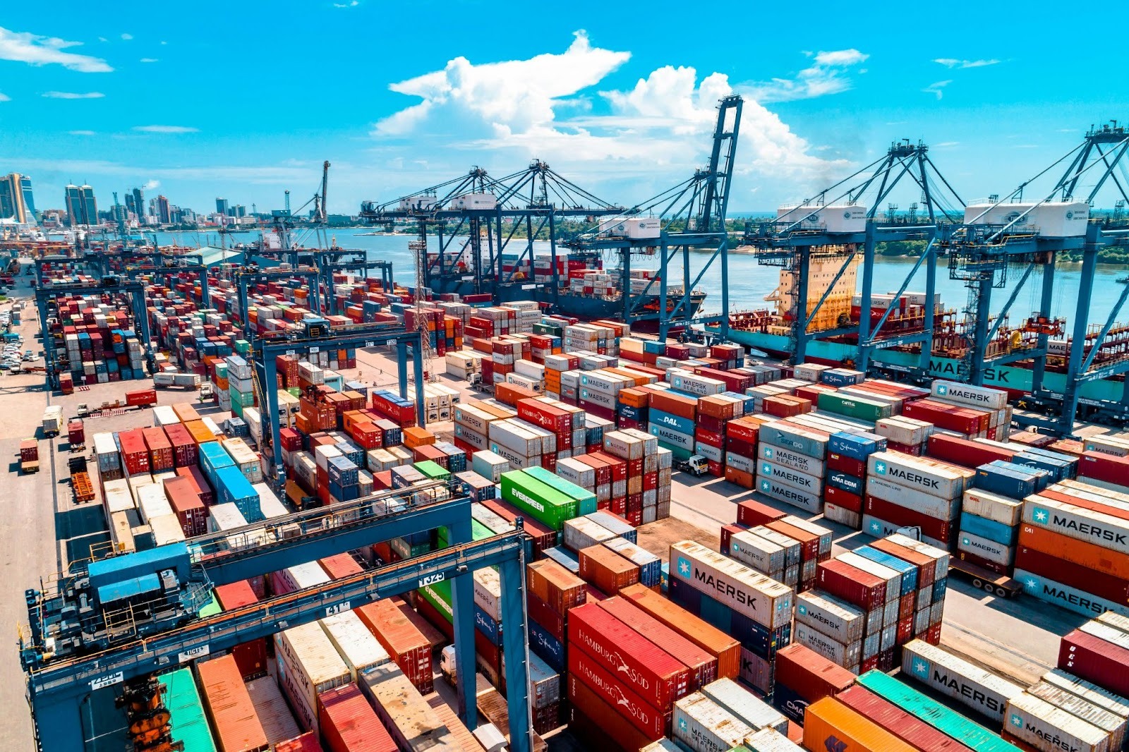 Global container shipping port with cargo containers and cranes representing international manufacturing supply chains