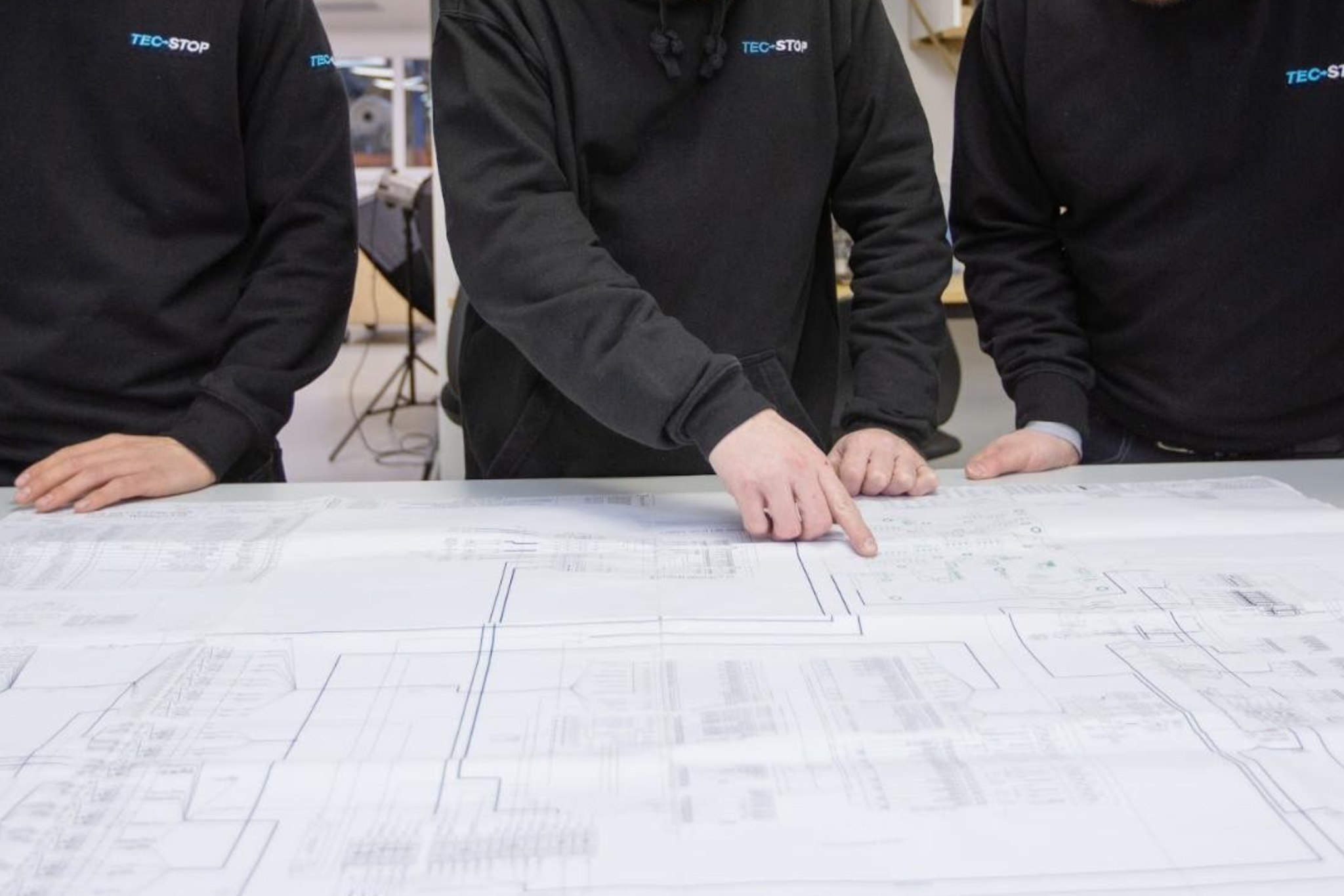 Engineers reviewing wiring harness drawings and electrical schematics during design and manufacturing planning