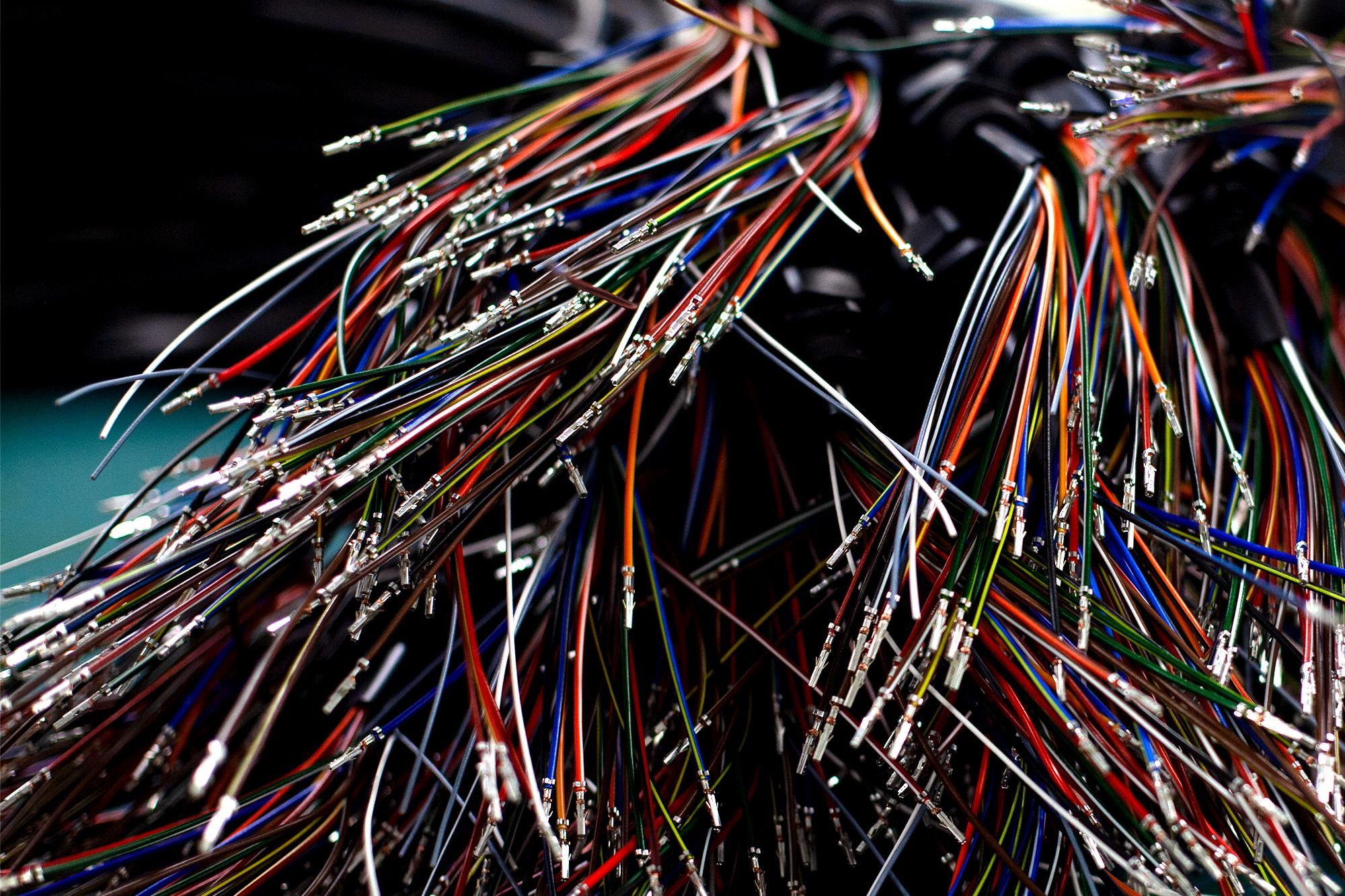 Multi-coloured terminated wires prepared for cable assembly with crimped terminals and connectors