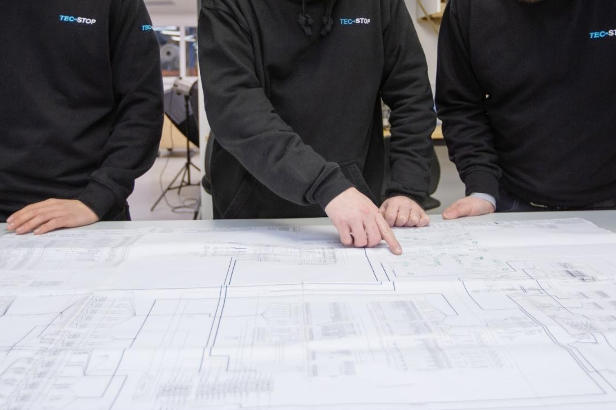 Tec-Stop engineers reviewing electrical panel schematics and wiring drawings during verification
