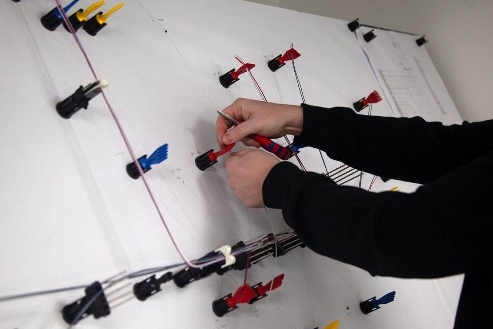 Prototype automotive wiring harness being assembled on a layout board