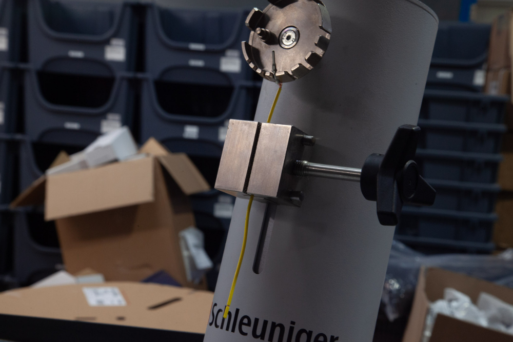 Pull-force testing equipment used to validate cable terminations during wiring harness manufacture