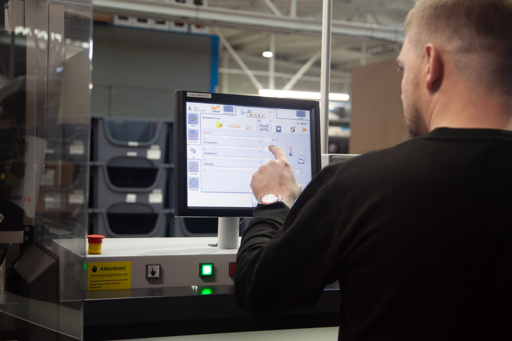 Tec-Stop engineer operating automated wire processing equipment during cable assembly manufacture