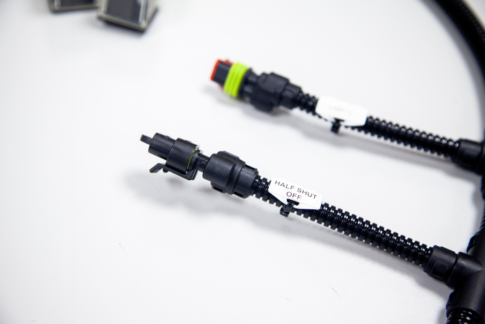 Sealed industrial connector with protective sleeving for IP-rated custom cable assemblies