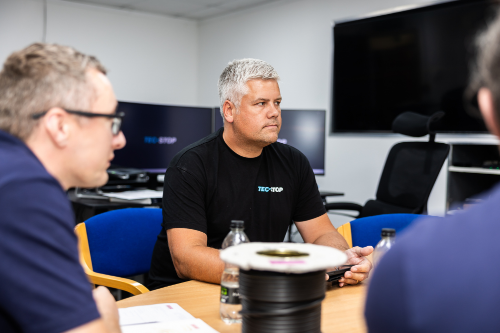 Engineering discussion between the Tec-Stop team during an OEM project review