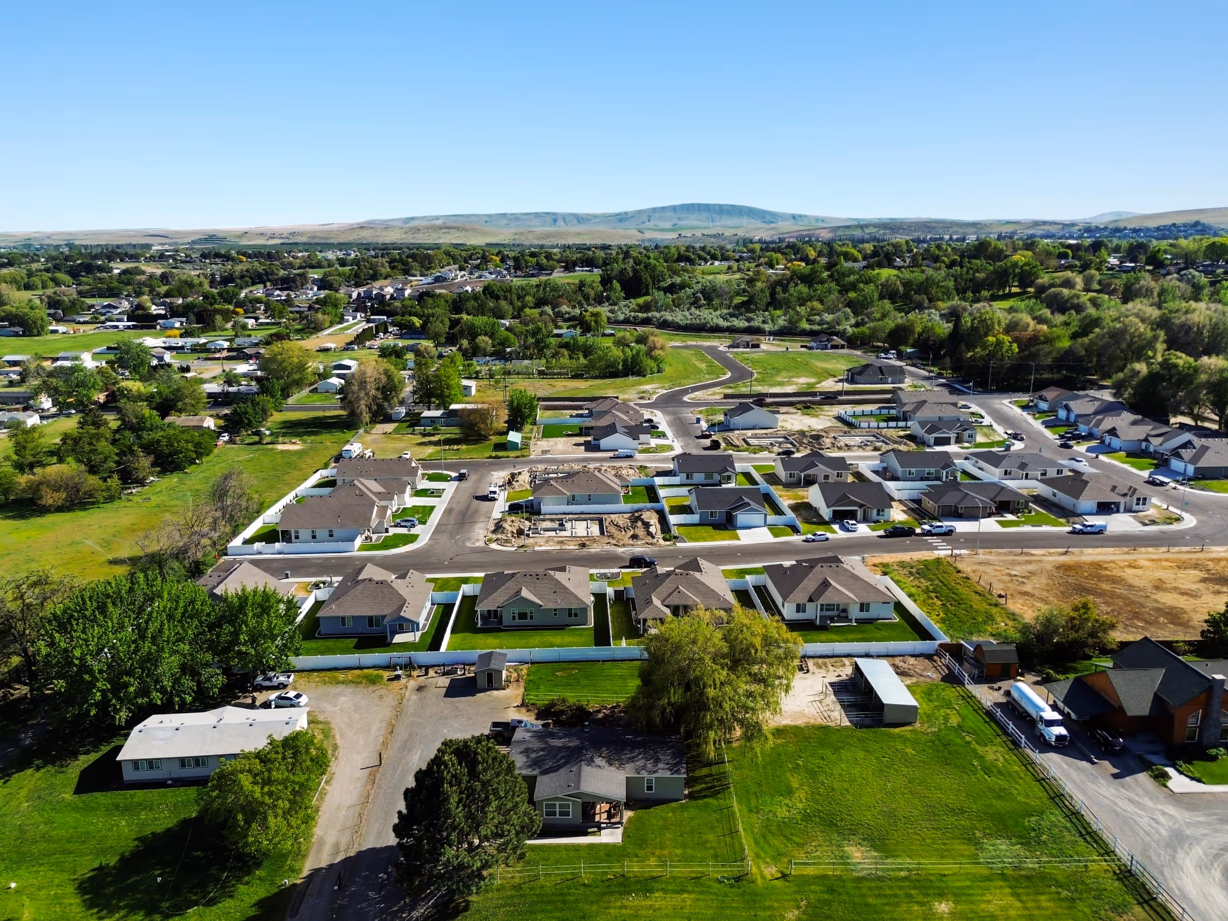 An aerial view of a housing estate in a rural area.
