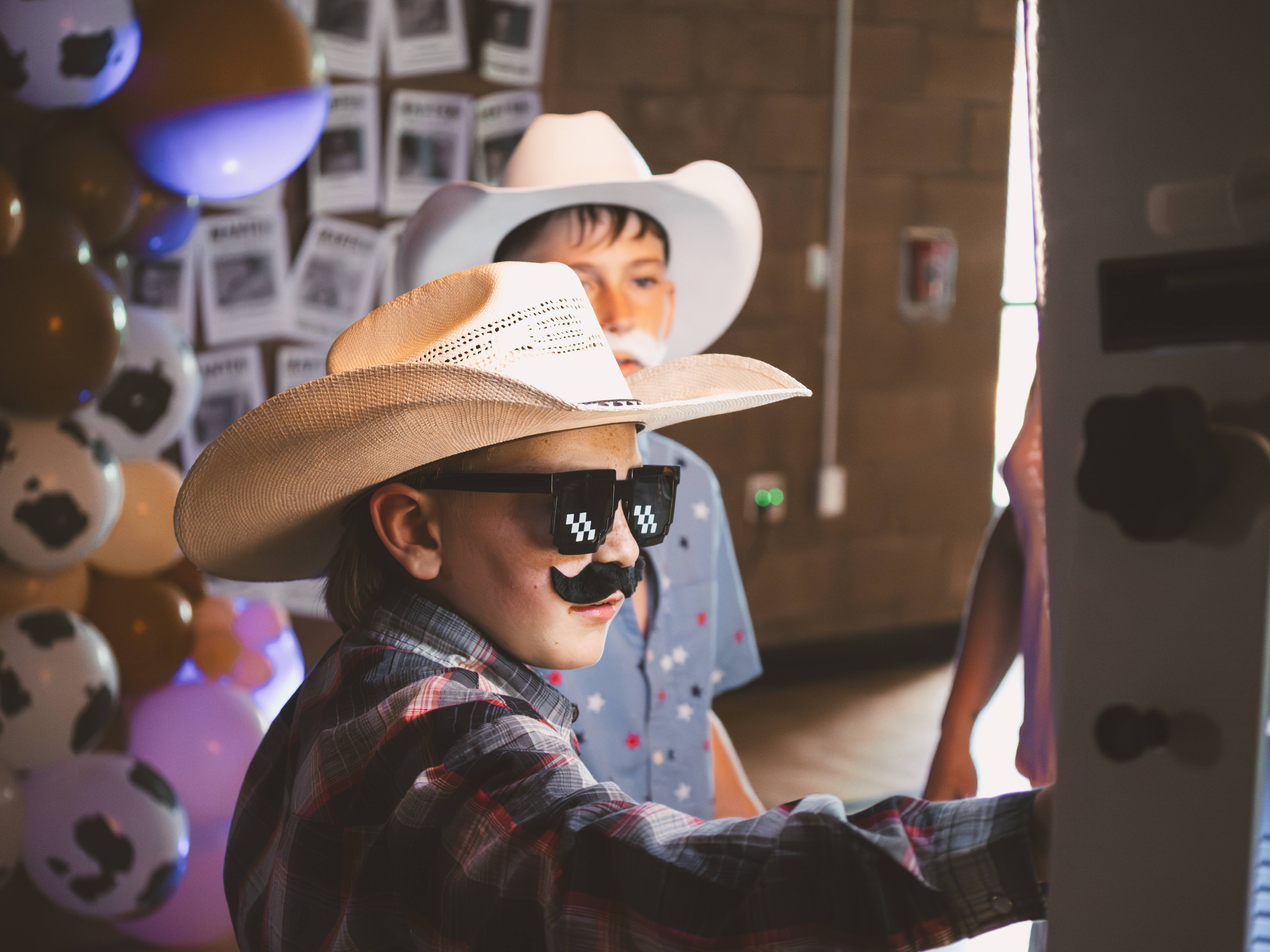 Guest wearing photo booth props while using the UrOn Photos booth
