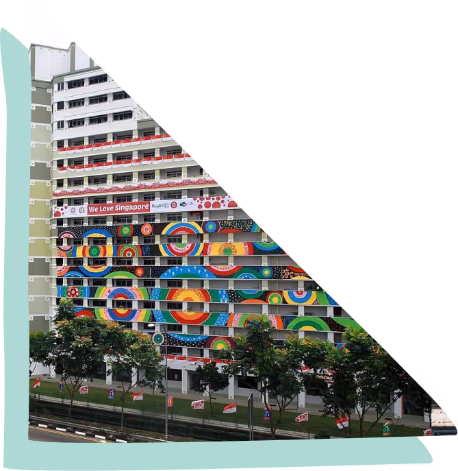 Multi-story building facade decorated with a large colorful circular mural and a banner reading 'We Love Singapore'.