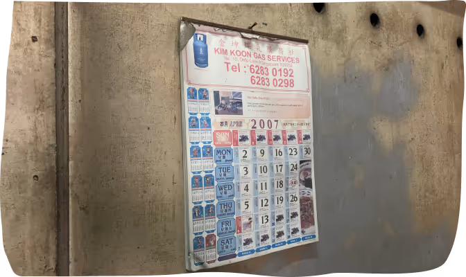 A 2007 calendar poster for Kim Koon Gas Services displayed on a stained concrete wall.