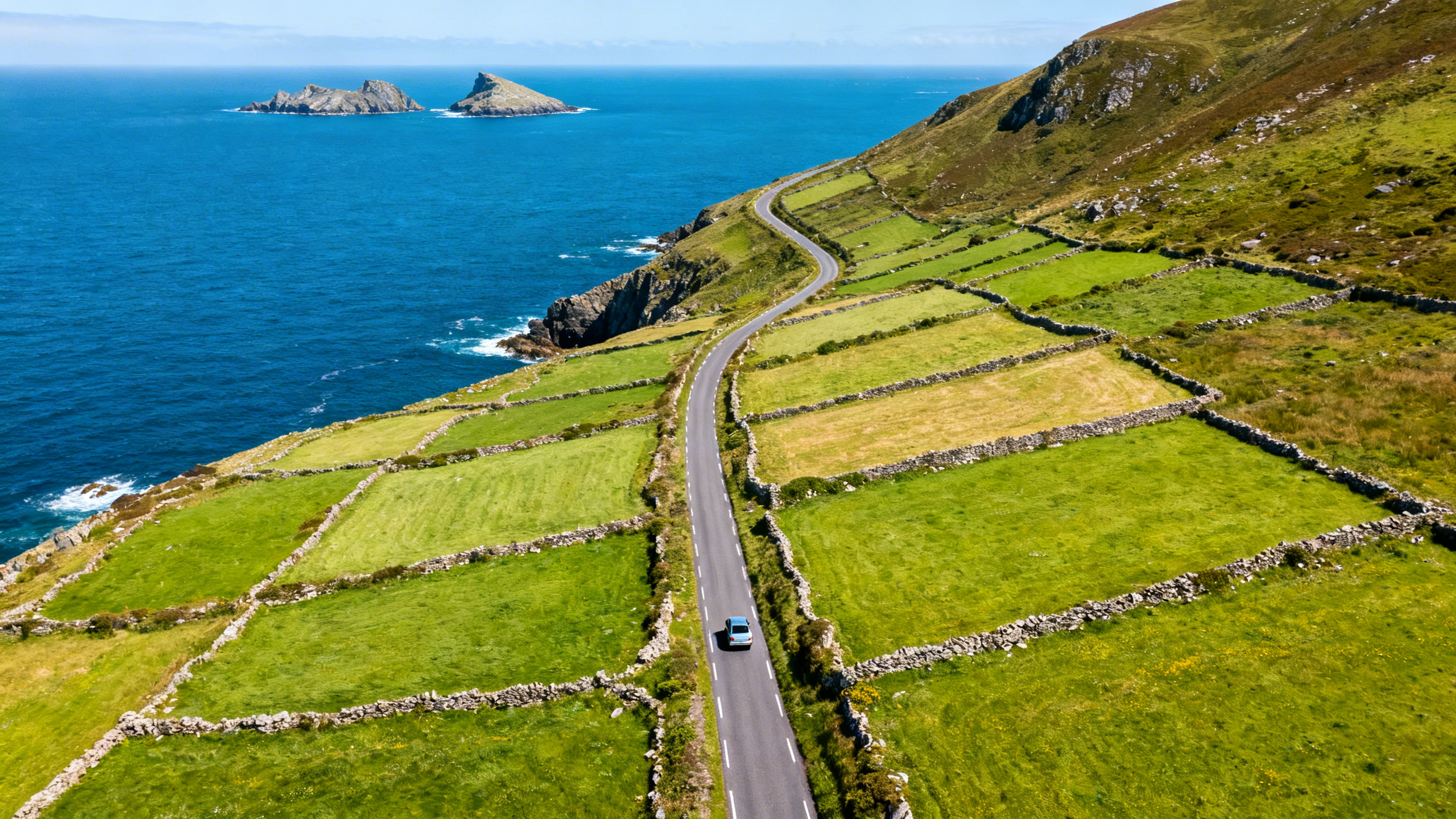 Aerial view of the Dingle Peninsula and the Blasket Islands from above, the narrow green headland extending into dark blue Atlantic water