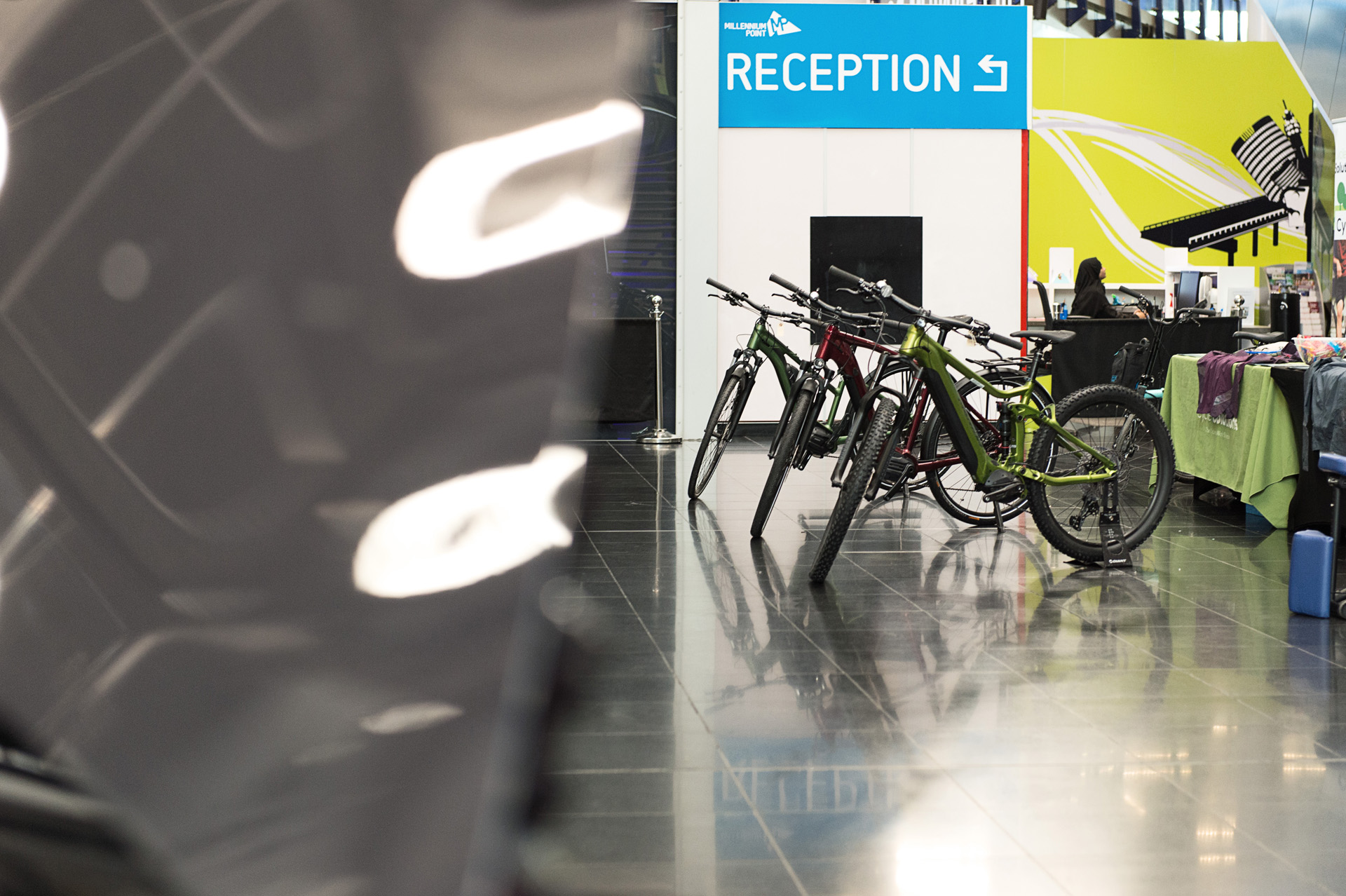 Bicycles displayed beside a reception desk as part of a workplace benefits fair