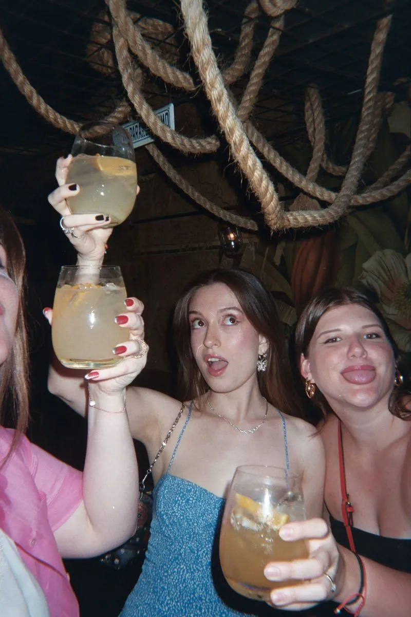Teammates raising cocktails at a group dinner during an Offsiteio offsite