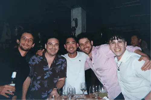 Teammates posing arm in arm after dinner at an Offsiteio offsite
