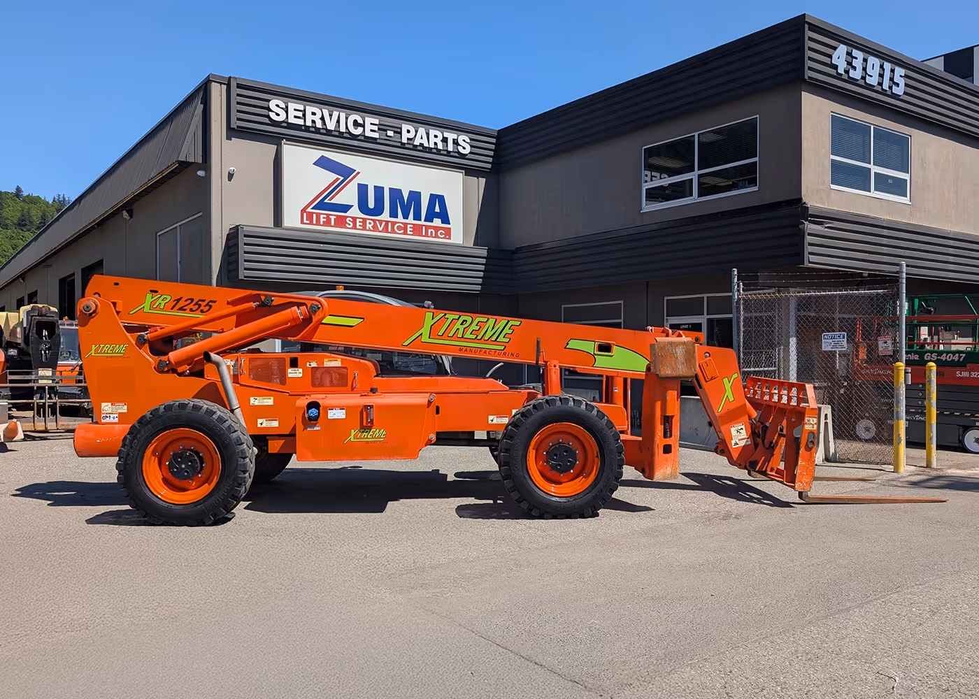 Orange 2017 Xtreme XR1255 Telehandler parked at Zuma Lift Service - side view | material handler