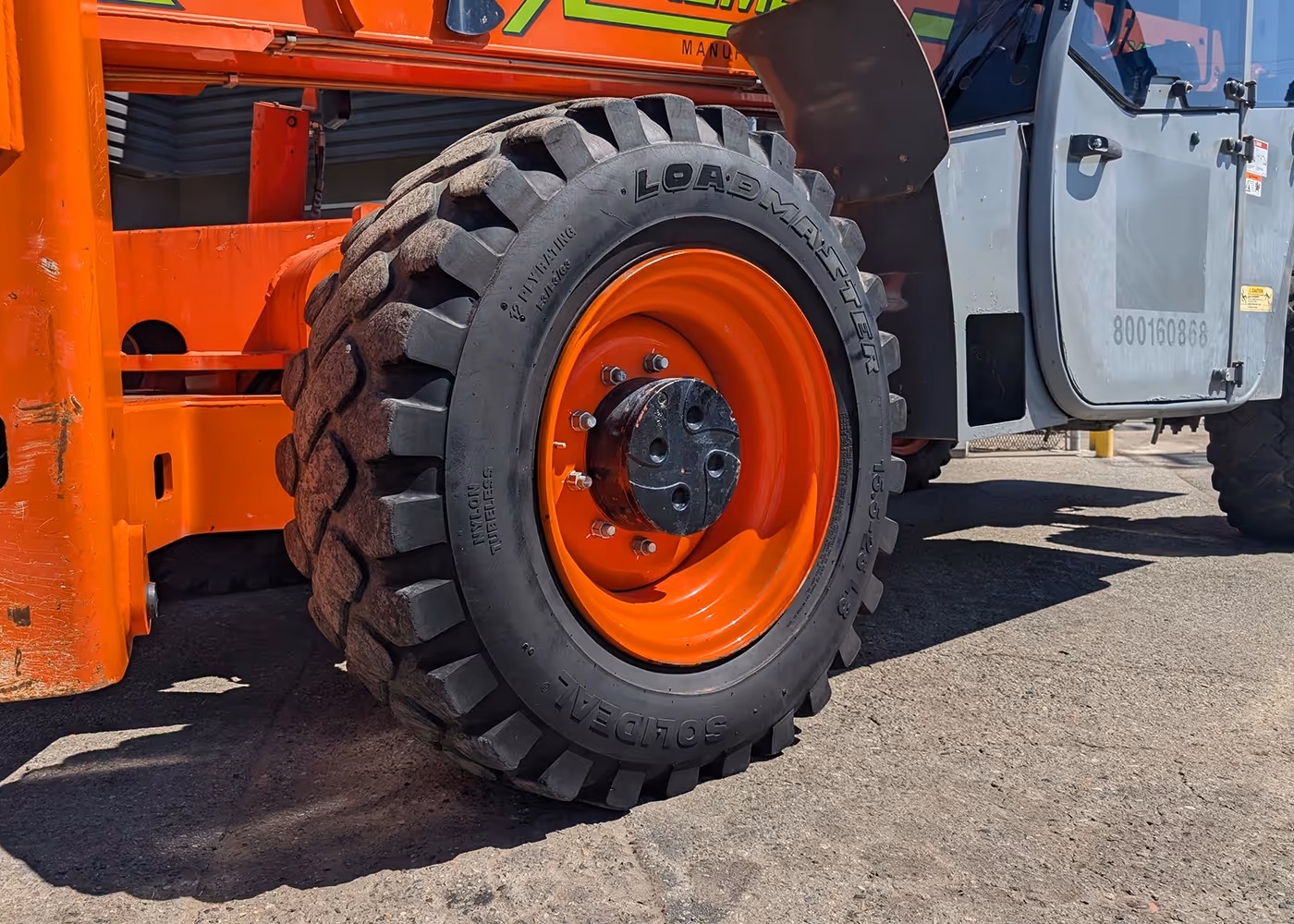 Solideal tire with orange rim, close-up, on 2017 Xtreme XR1255 Telehandler | equipment tire