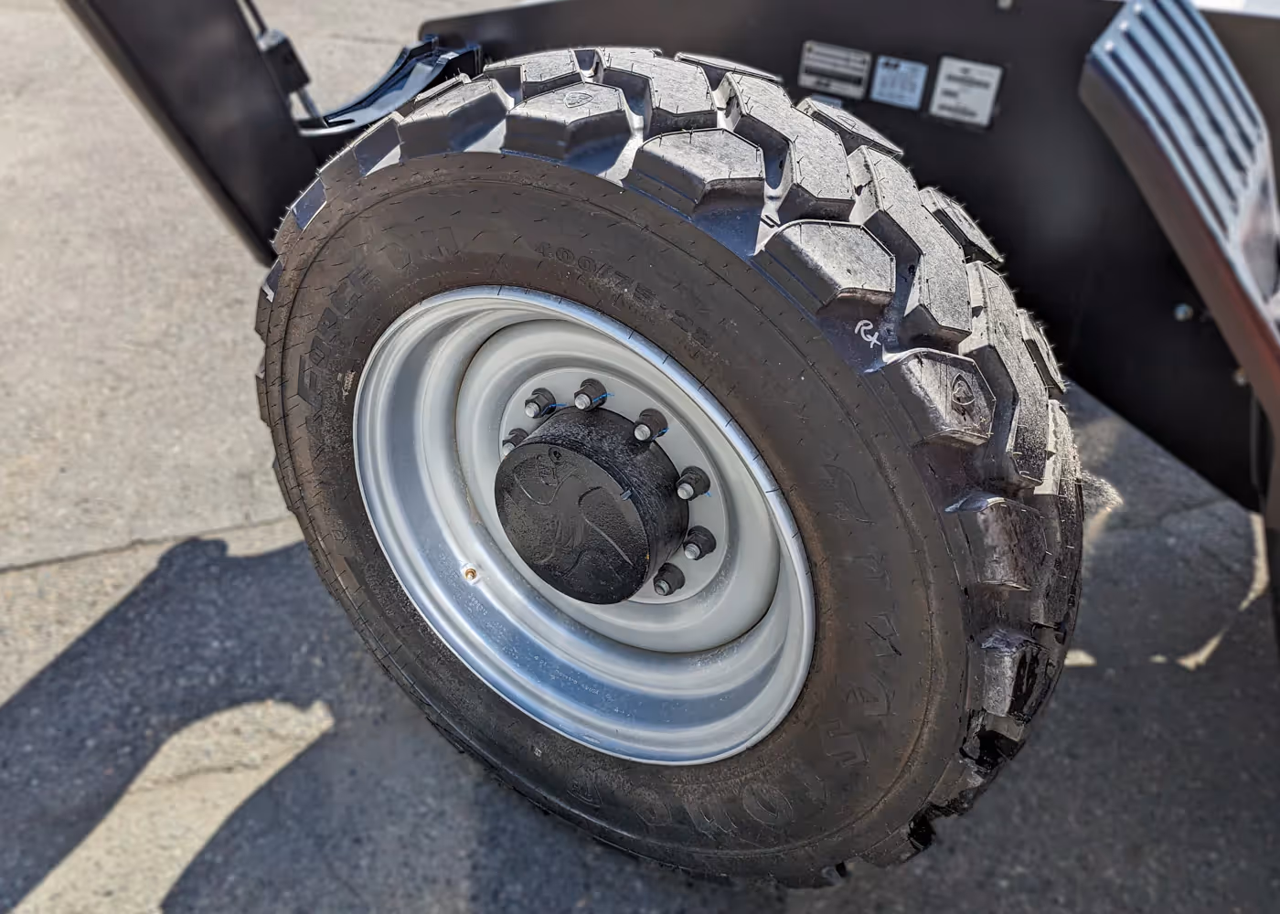  JLG 1055 telehandler front tire close-up with rugged tread pattern in Canada