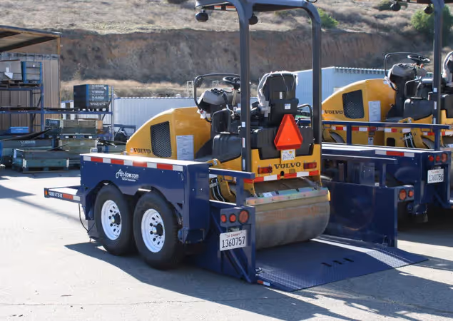 A Volvo road roller loaded onto the ground-level deck of an Air-Tow trailer for easy transport.