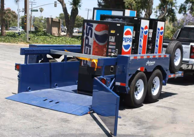 Air-Tow drop-deck trailer with lowered deck for easy loading of multiple Pepsi vending machines.